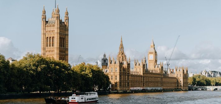The UK Houses of Parliament are seen in the distance from the Victoria Tower end, looking from across the River Thames in the foreground