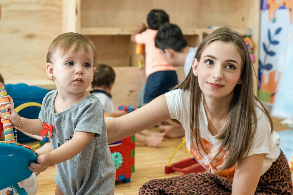 image of a toddler with a nursery teacher in a Montessori environment