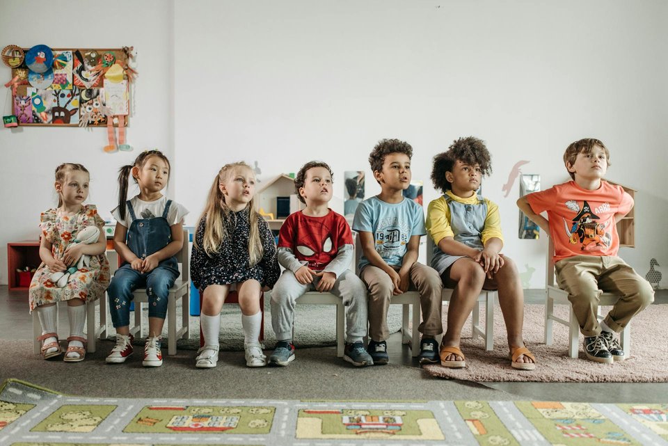 image of children sitting on chairs in nursery school