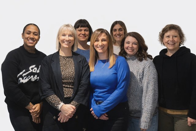 Posed photo of the members of the Family Services team stood together against a white background