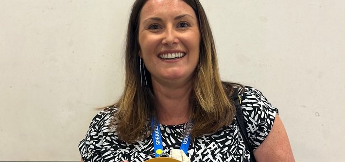A woman poses with an award