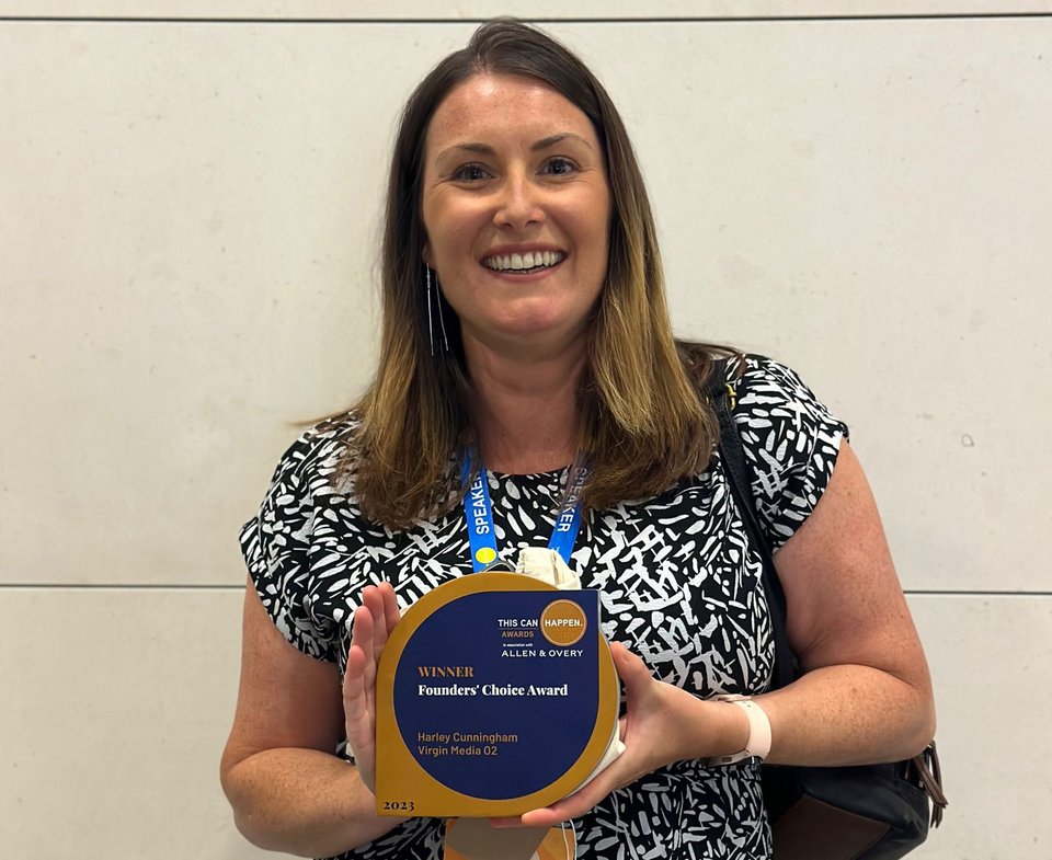 A woman poses with an award