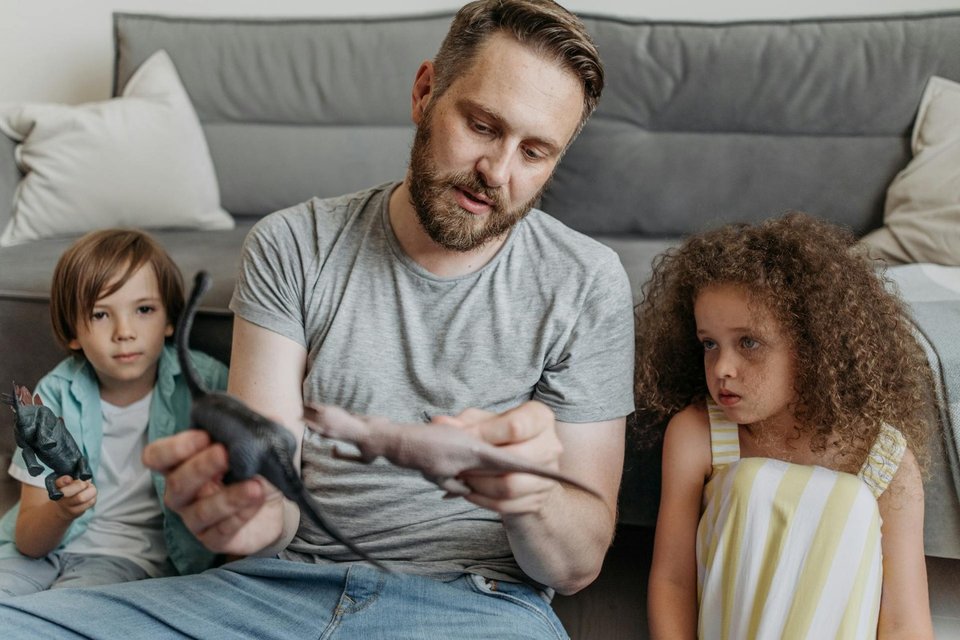 a father playing with his two children