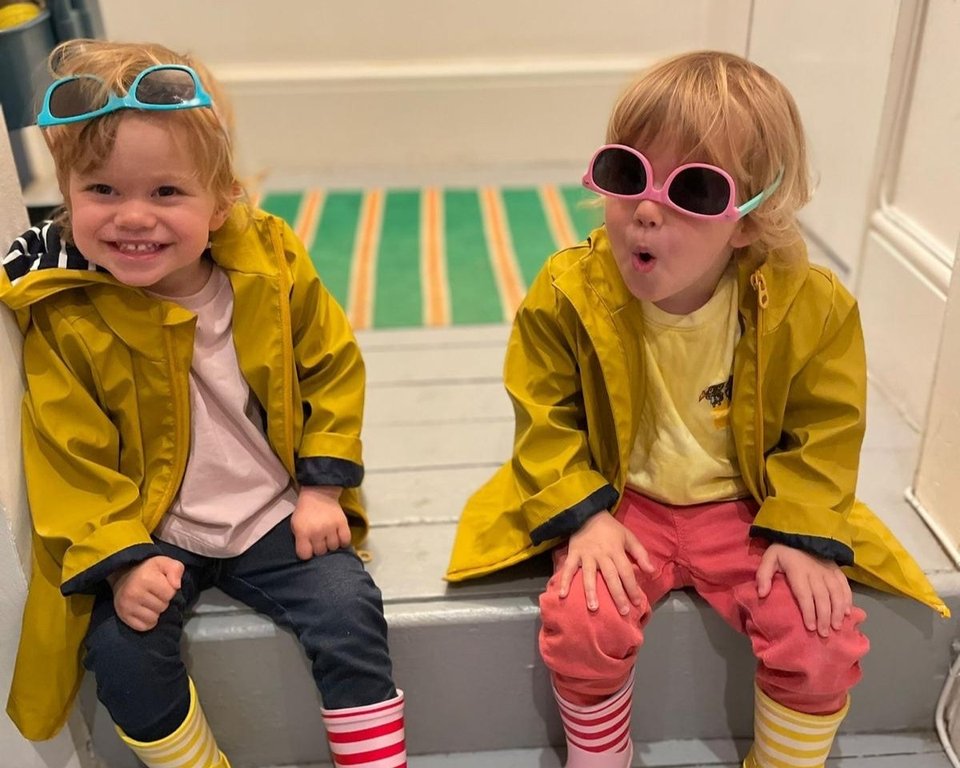 twin toddlers with sunglasses playing and smiling