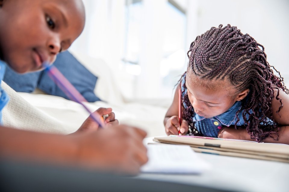 close up of two black girls doing homework