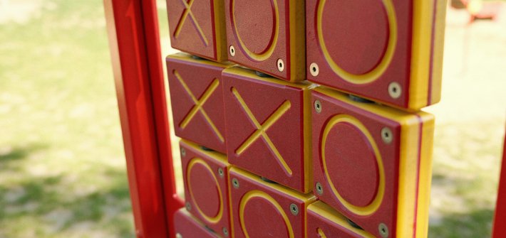 A close-up of a tic tac toe game in a park