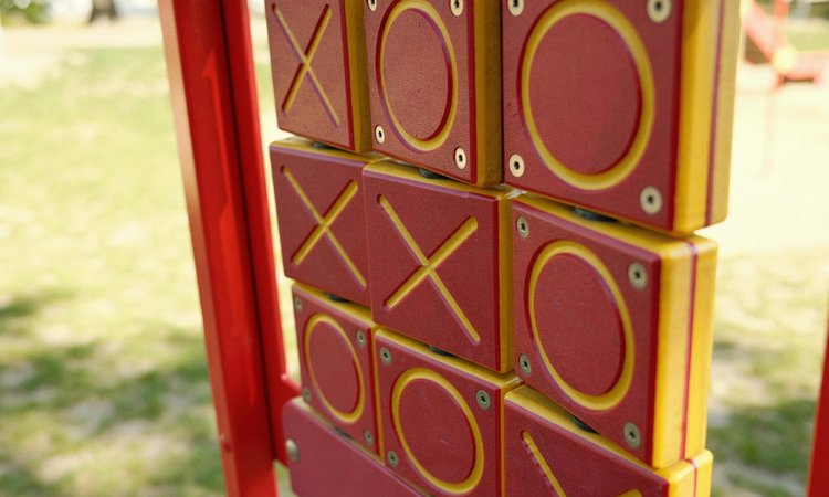 A close-up of a tic tac toe game in a park