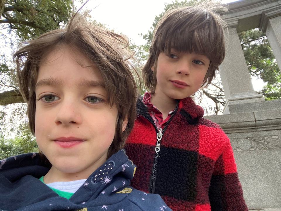 a selfie of twin boys in a park