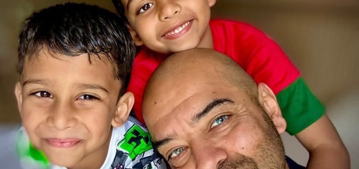 a selfie photo of a dad with his twin boys