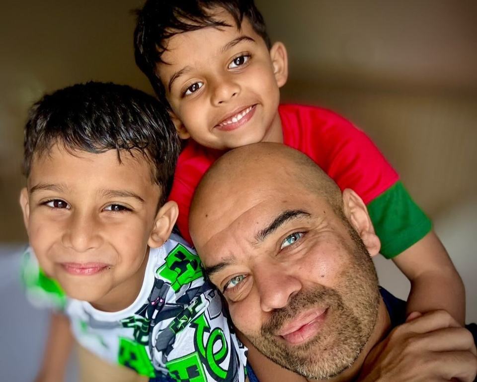 a selfie photo of a dad with his twin boys
