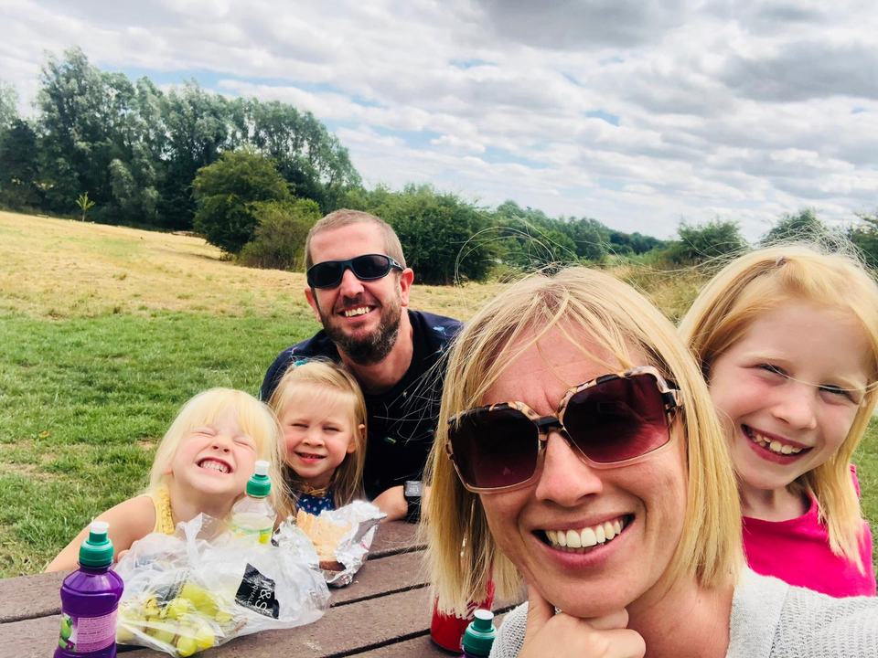 a selfie photo of a family of five in a country park