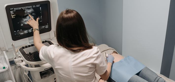 Female doctor conducting an ultrasound screening on a patient