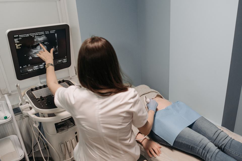 Female doctor conducting an ultrasound screening on a patient