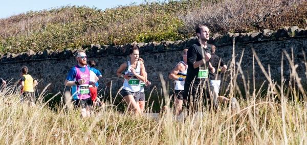 marathon runners running through the countryside