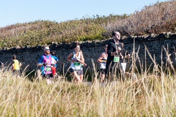 marathon runners running through the countryside